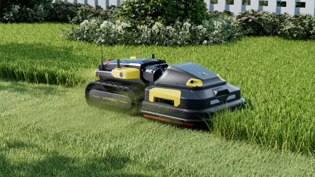 Tracked mower beside a garden border